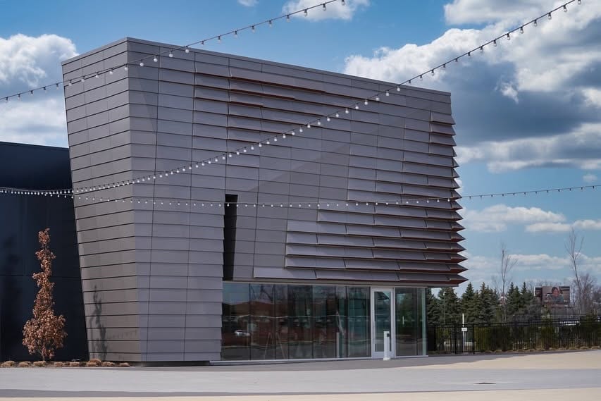 A modern commercial building with a full-height glass frontage